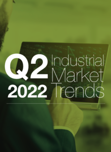 Business professional analyzing Q2 2022 industrial market trends on digital tablet